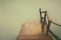 Rusty handrail going down on water with vintage effect Royalty Free Stock Photo