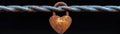Rusty Heart Lock on Twisted Metal Wire Against a Dark Background Royalty Free Stock Photo