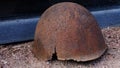 rusty helmet lies on the grave of a soldier