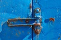 rusty hinge on old blue rusty metal door, closeup Royalty Free Stock Photo