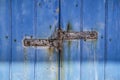 Rusty hinge on Old Blue wooden door in Spain Royalty Free Stock Photo