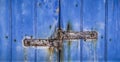 Rusty hinge on Old Blue wooden door in Spain Royalty Free Stock Photo