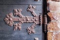 Rusty hinge of an old wooden door Royalty Free Stock Photo