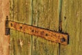 Rusty hinge of an old wooden door of country barn Royalty Free Stock Photo