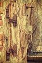 Rusty hinge on old wooden door. Royalty Free Stock Photo