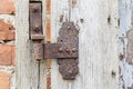 Rusty hinge on old wooden door. Royalty Free Stock Photo
