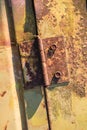 Rusty hinge on old yellow rusty metal door Royalty Free Stock Photo