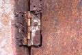 Rusty hinge welded steel on a rusty metal door texture background