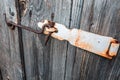 Old and rusty hook locks the old dried up wooden barn door Royalty Free Stock Photo