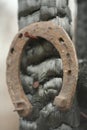 Rusty horseshoes on a burned wooden pole - rustic scene in a country style. Royalty Free Stock Photo