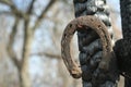 Rusty horseshoes on a burned wooden pole - rustic scene in a country style. Royalty Free Stock Photo