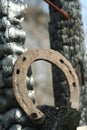 Rusty horseshoes on a burned wooden pole - rustic scene in a country style. Royalty Free Stock Photo