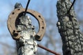 Rusty horseshoes on a burned wooden pole - rustic scene in a country style. Royalty Free Stock Photo