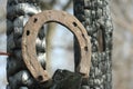 Rusty horseshoes on a burned wooden pole - rustic scene in a country style. Royalty Free Stock Photo