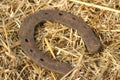 Rusty horseshoes on a straw background - rustic scene in a country style. Old iron Horseshoe - good luck symbol and mascot of well Royalty Free Stock Photo