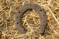 Rusty horseshoes on a straw background - rustic scene in a country style. Old iron Horseshoe - good luck symbol and mascot of well Royalty Free Stock Photo