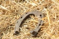 Rusty horseshoes on a straw background - rustic scene in a country style. Old iron Horseshoe - good luck symbol and mascot of well Royalty Free Stock Photo