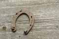 Rusty horseshoes on a wooden background - rustic scene in a country style. Royalty Free Stock Photo