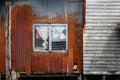 Rusty hovel in slum area in Thailand, house frontage and facade with rusty corrugated sheet and old wood Royalty Free Stock Photo