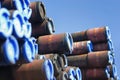 Ends of a stack of pipes covered with blue caps.