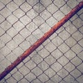 Rusty iron chain wire fence on cement wall Royalty Free Stock Photo