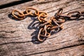 Rusty iron chain on a wooden background Royalty Free Stock Photo