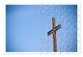 Rusty iron cross against a blue background - Rebuild our faith Royalty Free Stock Photo