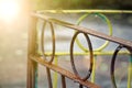 Rusty iron fence with damaged steel circles. Royalty Free Stock Photo