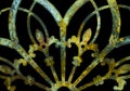 Rusty iron grunge green and yellow lacy metal decoration with fleur-de-lis isolated on black