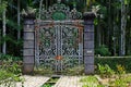 An old double-columned portal and iron gate in the middle of the vegetation. Sao Paulo Botanical Garden Royalty Free Stock Photo