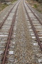 Rusty iron train tracks near a train station