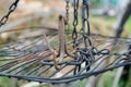 Rusty iron triple hook on grate hanging on chains Royalty Free Stock Photo