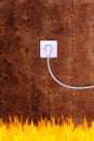 Rusty iron wall with an electrical outlet and fire Royalty Free Stock Photo