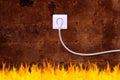 Rusty iron wall with an electrical outlet and fire Royalty Free Stock Photo