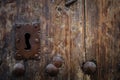 Rusty keyhole in old wooden door