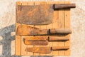 Rusty knifes on wooden tiles, farmer equipment in Thailand