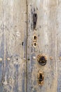 The rusty knocker and locks on a very old wooden door Royalty Free Stock Photo