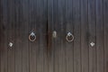 Rusty knockers on a wooden gates