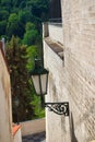 A rusty lamp on a wall in narrowest Prague street. Royalty Free Stock Photo