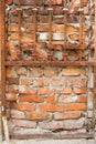 Rusty lattice on the background of an old red brick wall, background or concept Royalty Free Stock Photo