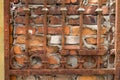 Rusty lattice on the background of an old red brick wall, background or concept Royalty Free Stock Photo