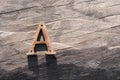 Rusty letter A sign lying on a wood texture in warm light Royalty Free Stock Photo