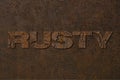 Rusty lettering word corrosion metal on dark worn grunge texture