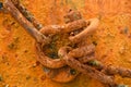 Rusty links of a chain on metal plate