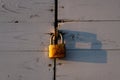 Rusty lock hanging on a wooden door Royalty Free Stock Photo