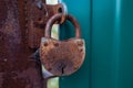 A rusty lock without a key hangs on a metal fence. Security concept. Selective focus. Copy space Royalty Free Stock Photo