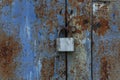 Rusty lock on an old blue metal gate. Close-up Royalty Free Stock Photo