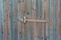 Rusty locking slide latch on frozen wooden old door in the winter Royalty Free Stock Photo