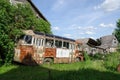Rusty lonely broken bus in country green field