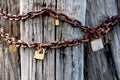 Rusty love locks on an old pole, a romantic gesture of undying love